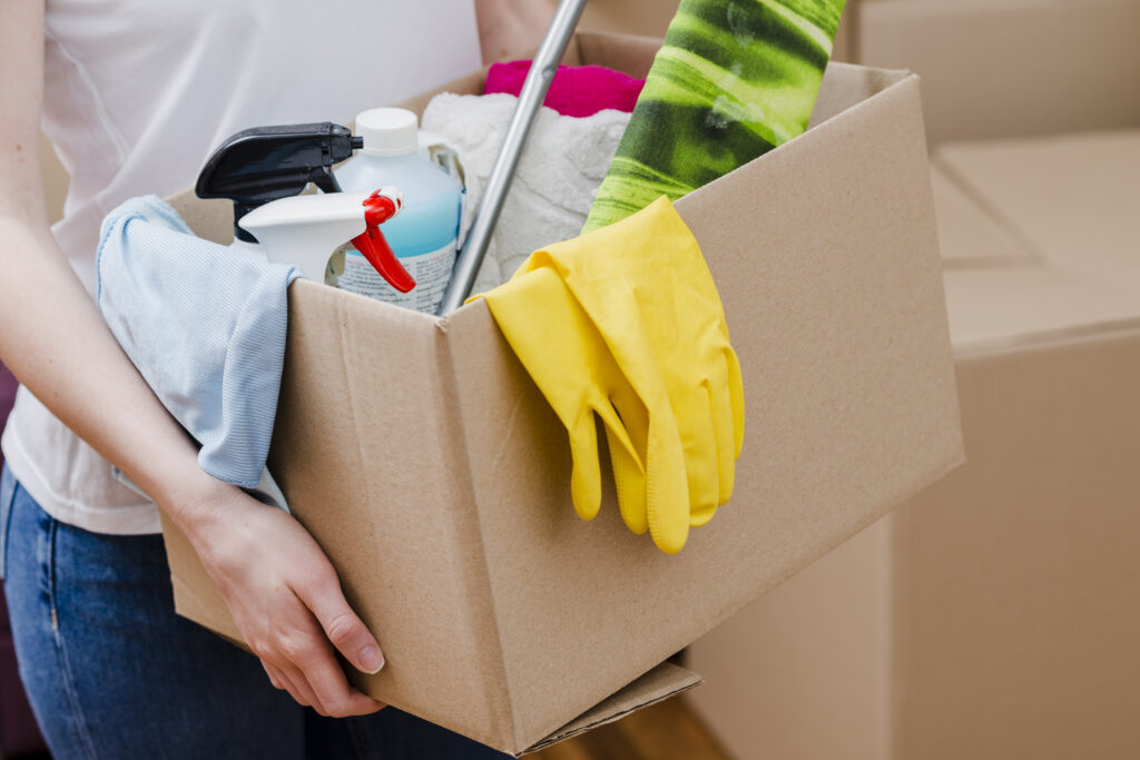 crop woman carrying box with things